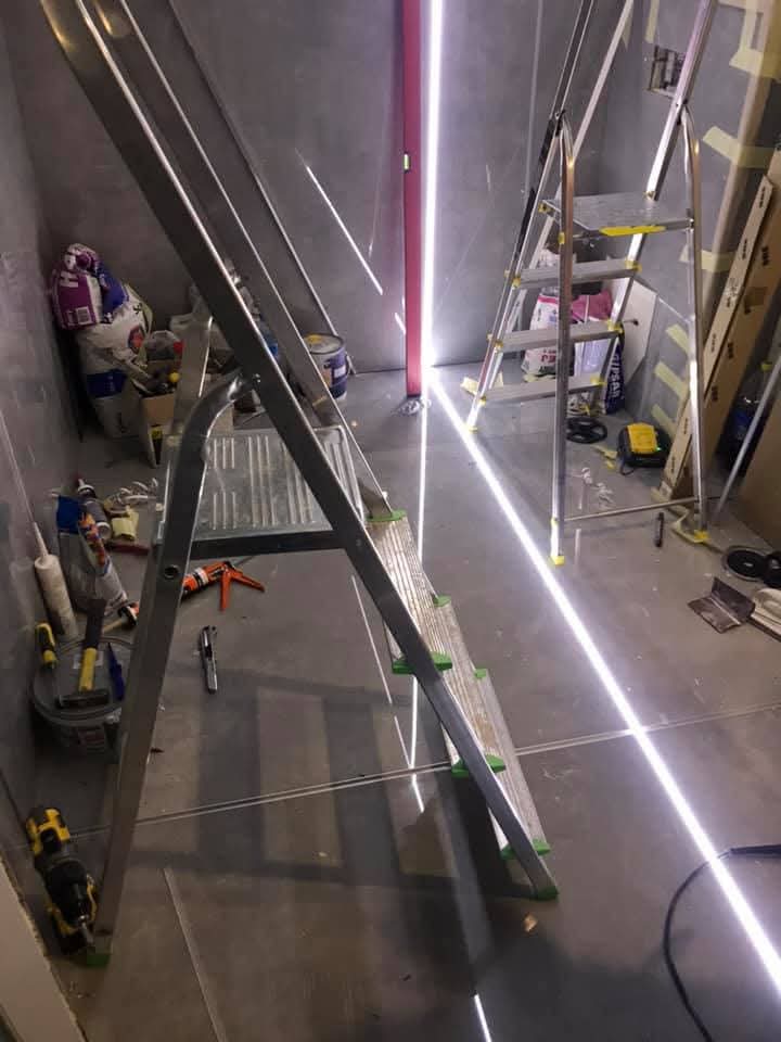 Bagno con grandi lastre e fughe LED a Toruń
